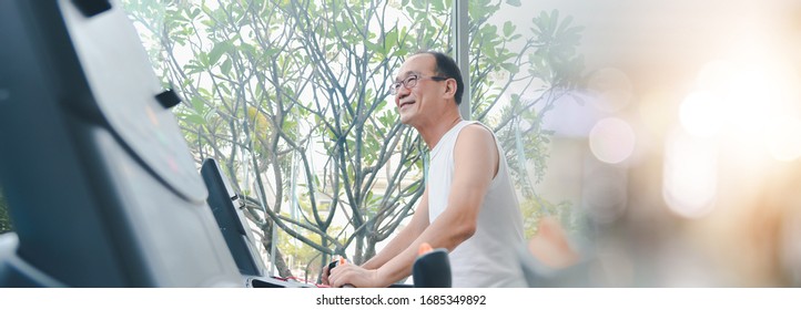 Senior Asian Man Exercise  Workout At Sport Gym. Elderly Healthy Man Lifestyle At Gym Club. 