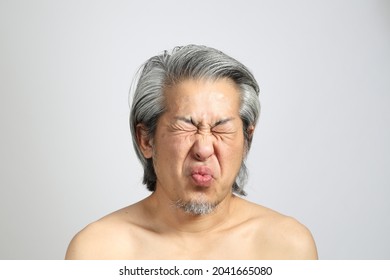 The senior Asian man portrait with no retouched skin in the white background.