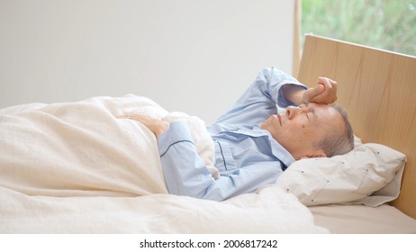 senior asian man sleeping on the bed