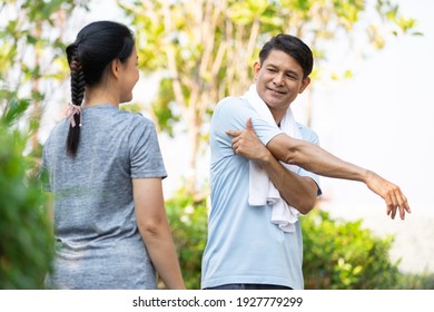 Senior Asian Man Stretching And Exercising Outdoors