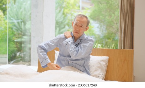 Senior Asian Man Stretching On The Bed