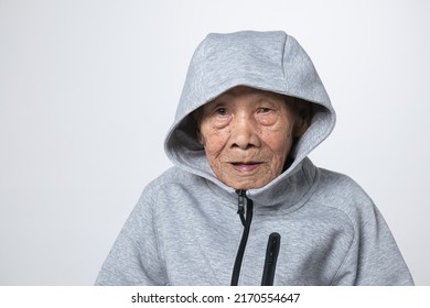 Senior Asian Man Wearing A Hoodie Sweater Or Cold Weather Zip Sweatshirt. A 95 Years Old Guy With A Cataract Eye Problem With A Gray 
Cool Shirt.