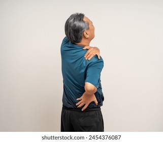 Senior asian old man with sportswear has an inflamed neck and shoulder pain. Old man senior has problem with structural posture - Powered by Shutterstock