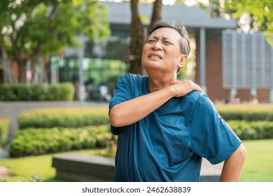 Senior asian old man with sportswear has an inflamed neck and shoulder pain. Old man senior has problem with structural posture - Powered by Shutterstock