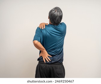 Senior asian old man with sportswear has an inflamed neck and shoulder pain. Old man senior has problem with structural posture - Powered by Shutterstock