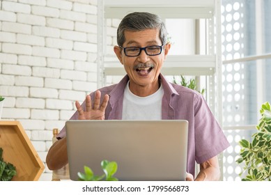 Senior Asian Retirement Old Man In Casual Outfit Doing A Hobby With Happy And Relax Using Computer Laptop For Video Call Or Facetime In Greenhouse Garden Farm