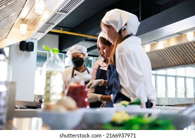 Senior asian woman chef teach student. Cooking class. culinary classroom. group of happy young woman multi-ethnic students are focusing on cooking lessons in a cooking school.  - Powered by Shutterstock