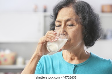 Senior Asian Woman Drinking Milk At Home