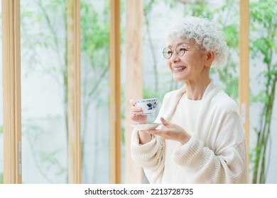 senior asian woman drinking tea - Powered by Shutterstock