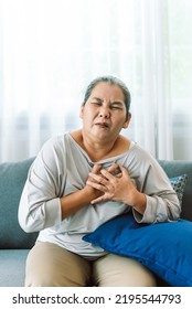 Senior Asian Woman Has Chest Pain. Elderly Woman Has Heart Disease. Emergency Signs Of Heart Attack Symptoms. People Need Urgent Help From Doctor.