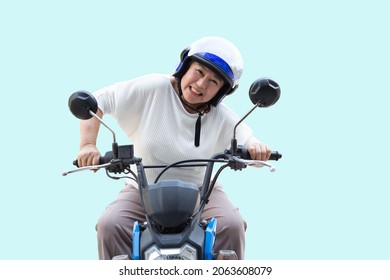 Senior Asian woman riding motorcycle isolated on light blue background, Happy active old age and lifestyle concept