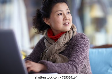 Senior Asian Woman Using Laptop 