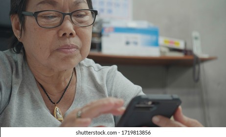 Senior Asian Woman Using Smart Phone.