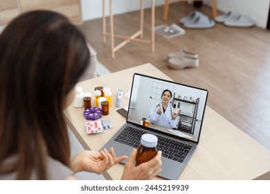 Senior Asian woman video calling with doctor on tablet, consultation health issues and medication online. Doctor concept of telemedicine - Powered by Shutterstock