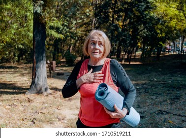 Senior Asthmatic Woman Without Air Having Problem With Breathing Outdoors After Exercise.Old Breathless Woman Holding Chest Having Trouble With Lungs And Heart.