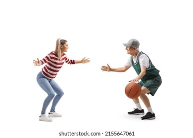 Senior Athlete Playing Basketball With A Casual Young Woman Isolated On White Background