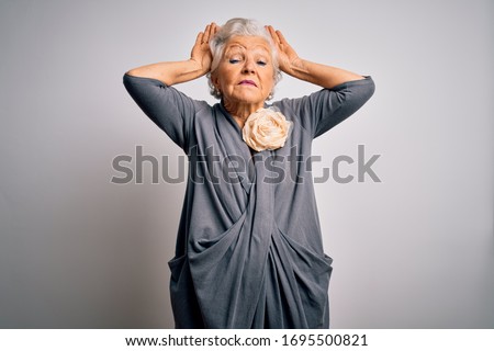 Senior beautiful grey-haired woman wearing casual dress standing over white background Doing bunny ears gesture with hands palms looking cynical and skeptical. Easter rabbit concept.