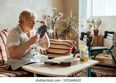 Senior Beauty And Skincare. Senior Elderly Plus Size Blonde Woman With Disability Applying Black Mascara Near Mirror At Home