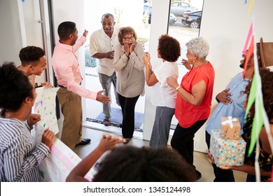 Senior Black Couple Arriving Home To A Family Surprise Party, Elevated View