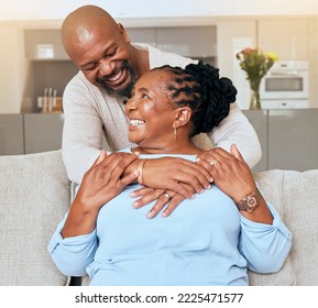 Senior black couple, hug and sofa with smile, love or happiness in home, living room or relax together. Elderly happy couple, African and embrace by couch, lounge care, romance or bonding - Shutterstock ID 2225471577