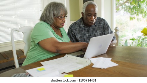 Senior Black Couple Looking At Laptop Computer