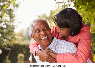 Senior Black Couple Piggyback, Looking At Each Other