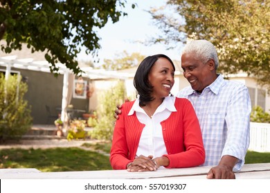 Senior Black Couple Standing Outside Their New House