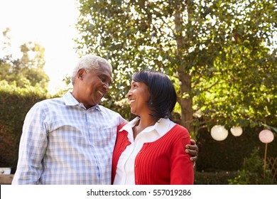 Senior Black Couple In Their Garden Looking At Each Other