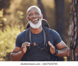 Senior black man hiking in nature for outdoor discovery, fitness walking and forest travel journey. Happy hiker person trekking in woods for retirement health, cardio wellness and camper holiday - Powered by Shutterstock