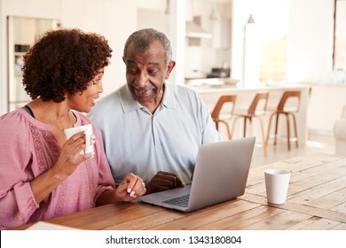 Senior Black Man And His Middle Aged Daughter Using A Laptop Together At Home, Close Up