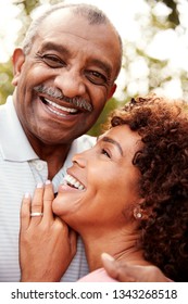 Senior Black Man And His Middled Aged Daughter Embracing And Laughing, Vertical