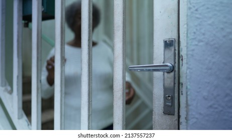 A Senior Black Woman Leaving House Person Opening Front Door