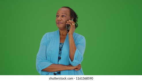 Senior black woman making phone call on green screen