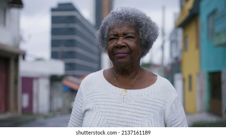 A Senior Black Woman Walking Forward In Urban Street