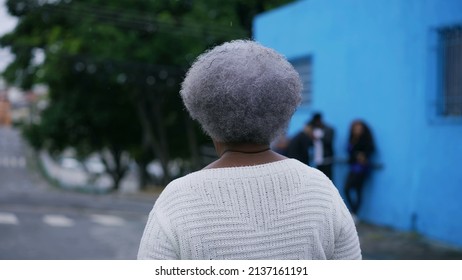 A Senior Black Woman Walking Forward In Urban Street