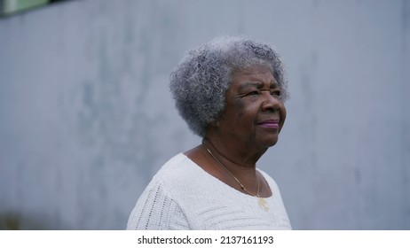 A Senior Black Woman Walking Forward In Urban Street