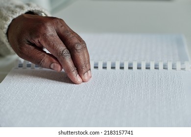 Senior blind man reading braille - Powered by Shutterstock