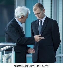 Senior Boss Talking With Young Office Worker, Vertical