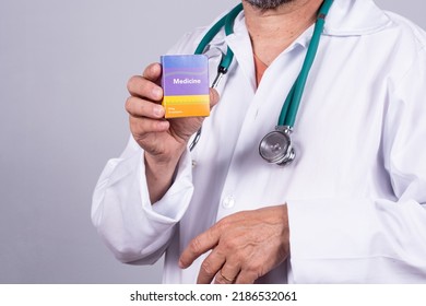 Senior Brazilian Doctor In White Coat, No Face, Holding Medicine Box