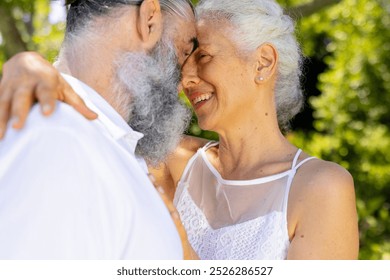 Senior bride and groom embracing and smiling outdoors, at wedding. love, happiness, affection, romance, elderly, togetherness - Powered by Shutterstock