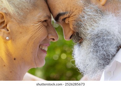 Senior bride and groom smiling and touching foreheads, at outdoor wedding. Friendship, happiness, togetherness, bonding, elderly, companionship - Powered by Shutterstock