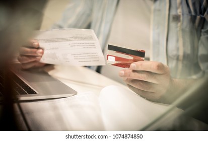 Senior Business Man Checking His Finance On Credit Card. Close Up. Focus Is On Hand.