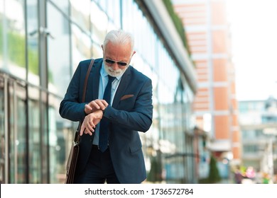 Senior Business Man Looking At Wristwatch