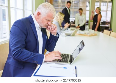 Senior Business Man Thinking About A Problem At The Laptop Computer In The Office