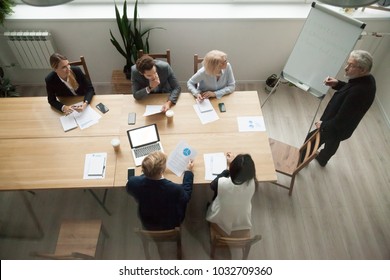 Senior Business Mentor Coaching Executive Managers Team At Corporate Group Meeting In Conference Room, Company Ceo Giving Presentation To Partners Discussing New Strategic Plan, Top View From Above