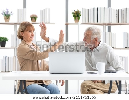 senior businessman and senior businesswoman missed giving hi five or touching hands pose for success at work