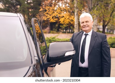 Senior Businessman Opening Car Door