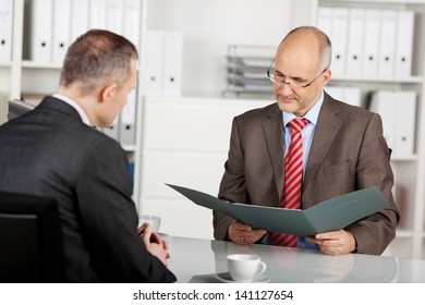 Senior businessman read the application in the office
