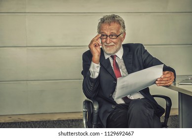 Senior Businessman Working In Office. Looking On Business Profits Chart On Paper. Mental Health, PTSD And Suicide Prevention. Post-traumatic Stress Disorder.