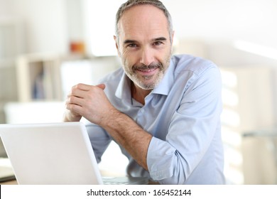 Senior Businessman Working On Laptop Computer